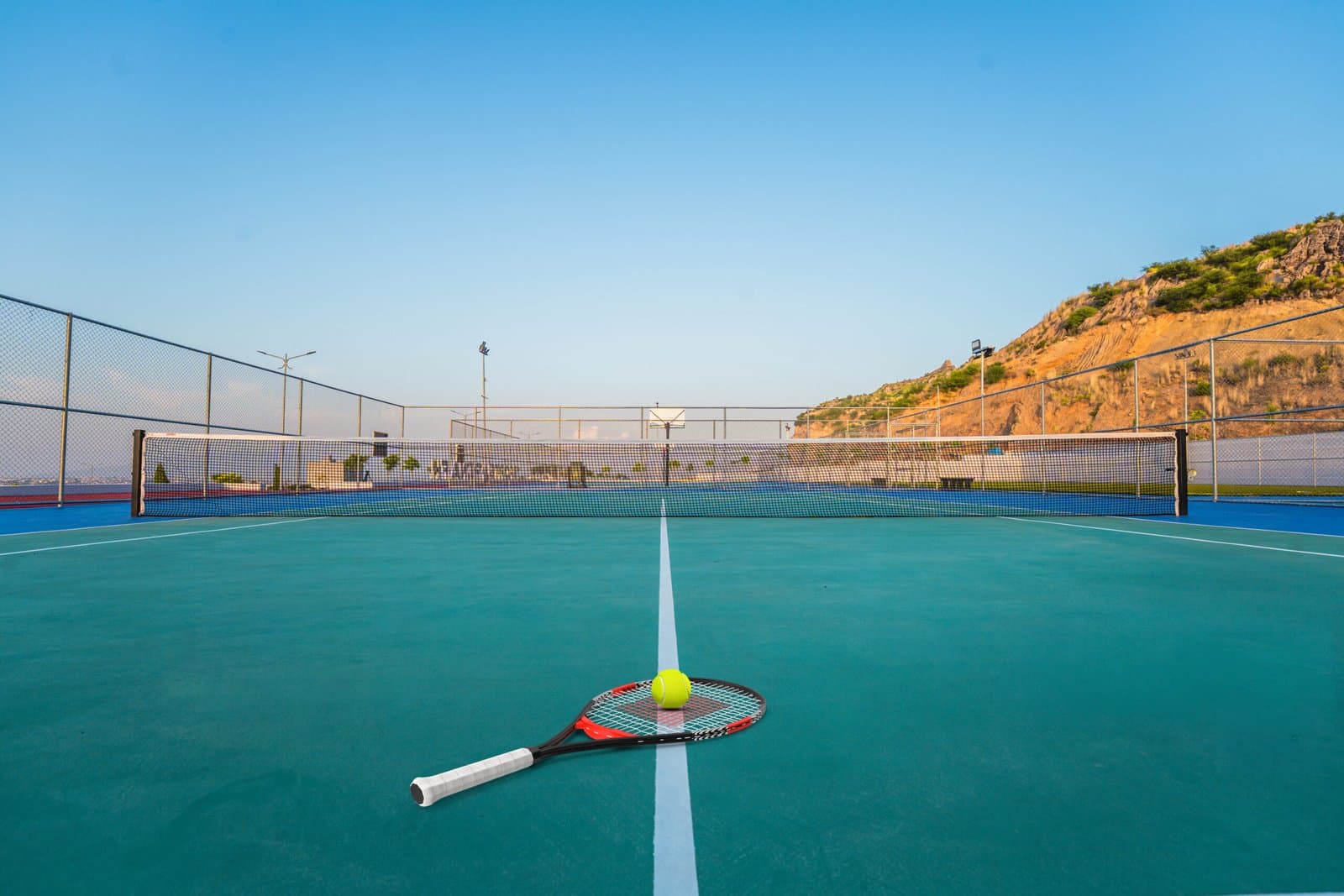 Tennis court at the Faisal Hills Sports Arena with hill views